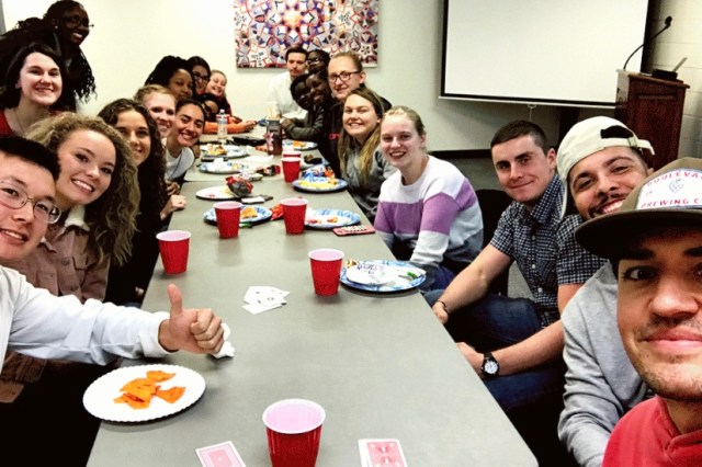 Group of college students gathered around a table