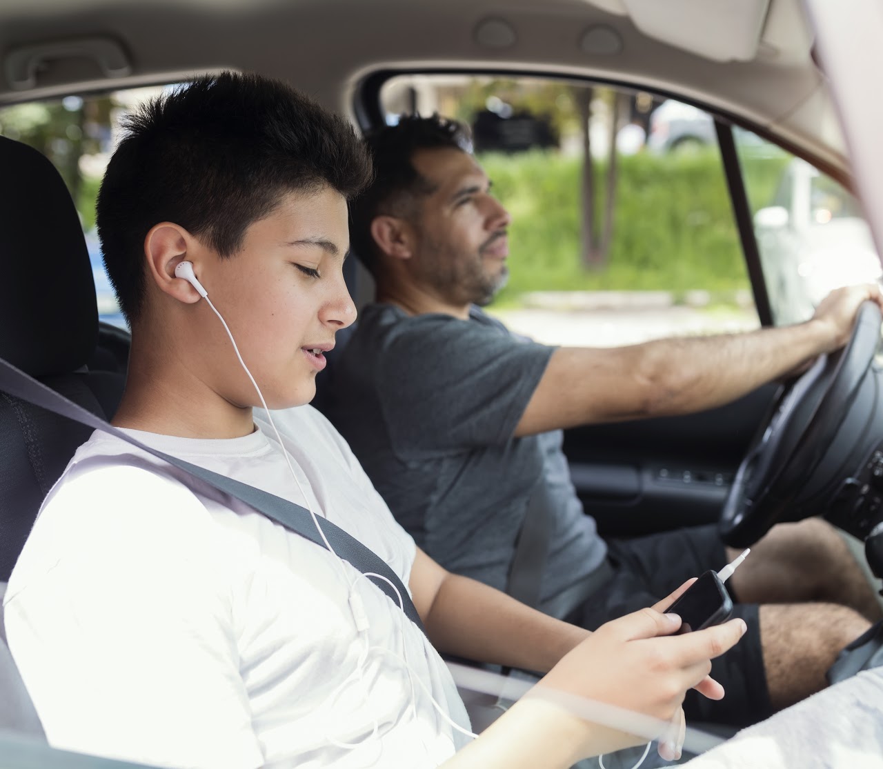 Parents1 Father and son spending quality time together.Traveling by car and listening music.