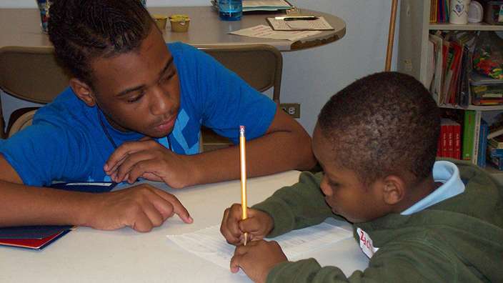 teen mentors a boy at a SAY Yes Center in the inner city