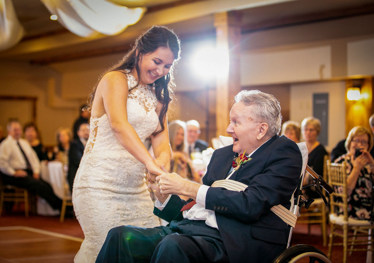 Bride dances with dad in wheelchair at wedding