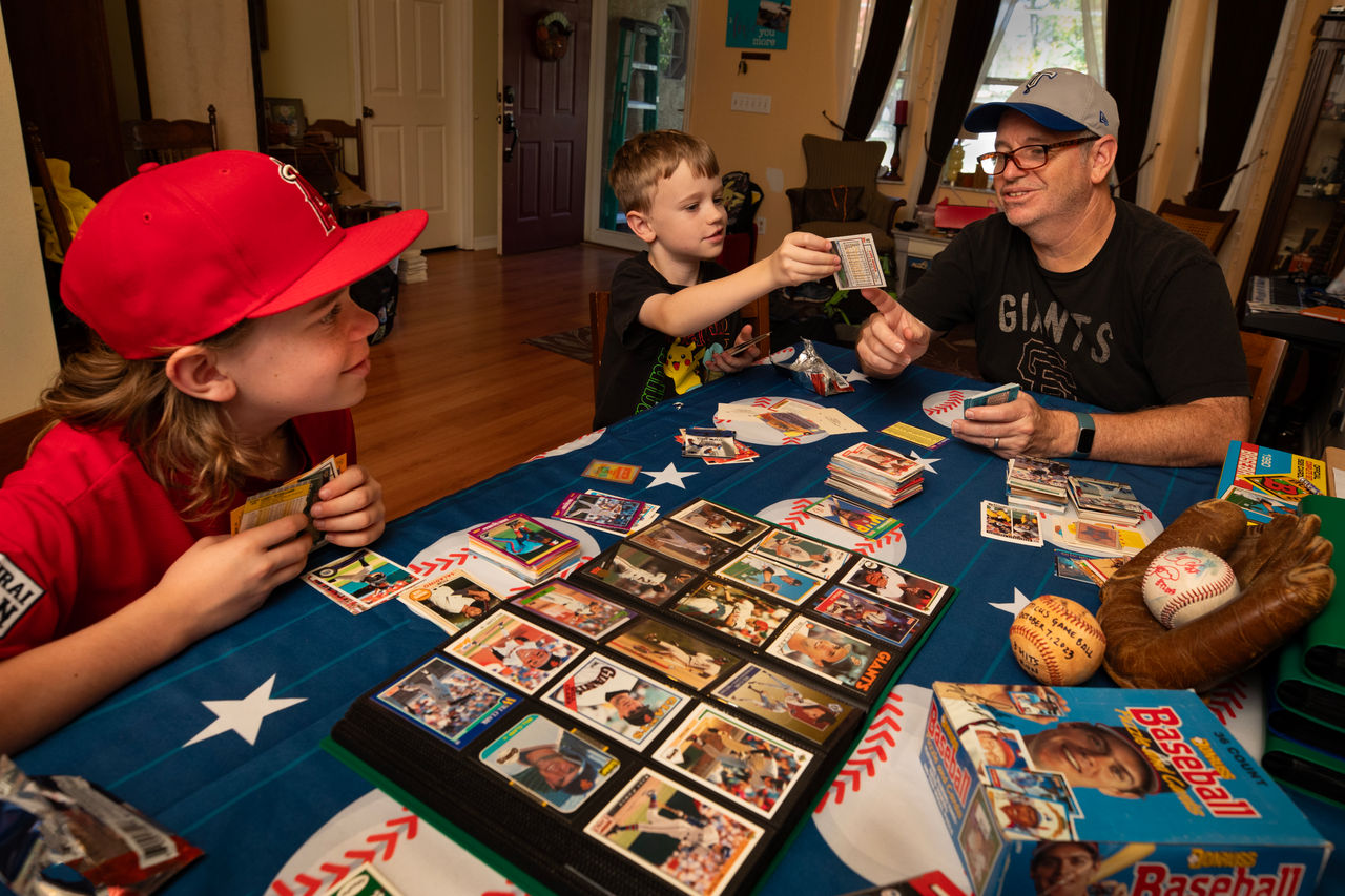 man with baseball cards and kids