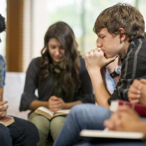 Diverse group of teens studying the Bible.