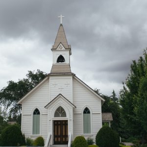 Small church exterior on overcast day.