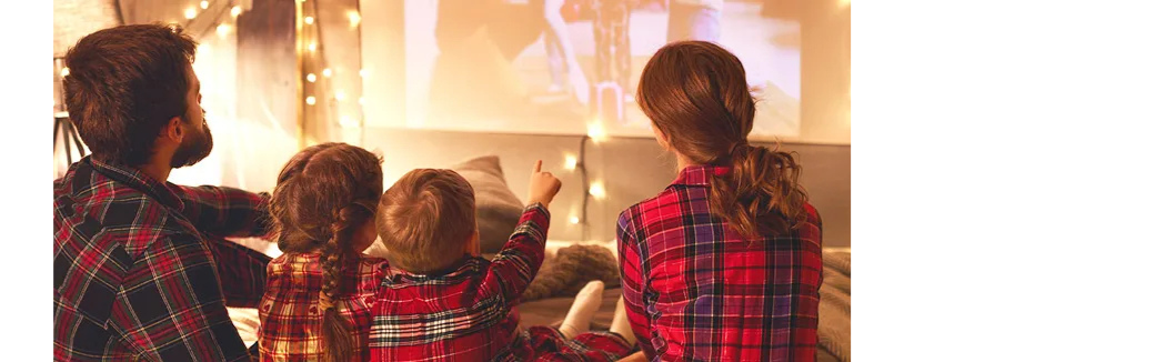 family watching projector on christmas eve