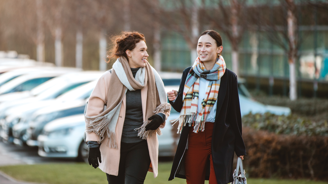women walking and talking while smiling