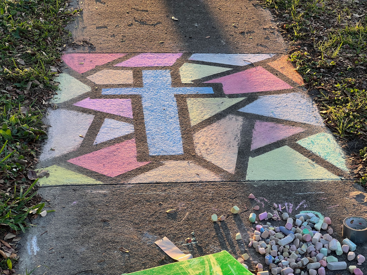 sidewalk chalk art with stained glass style cross