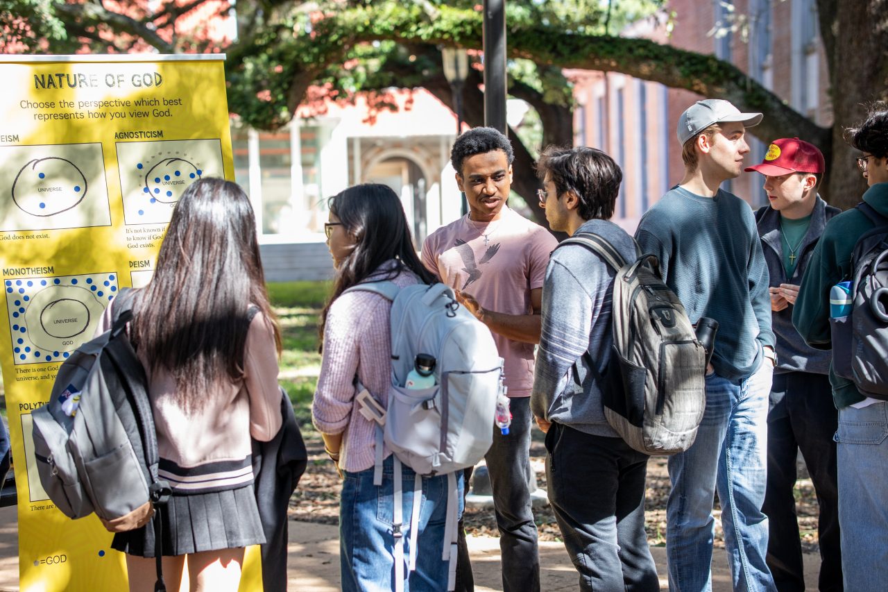 People talking around a board at University.